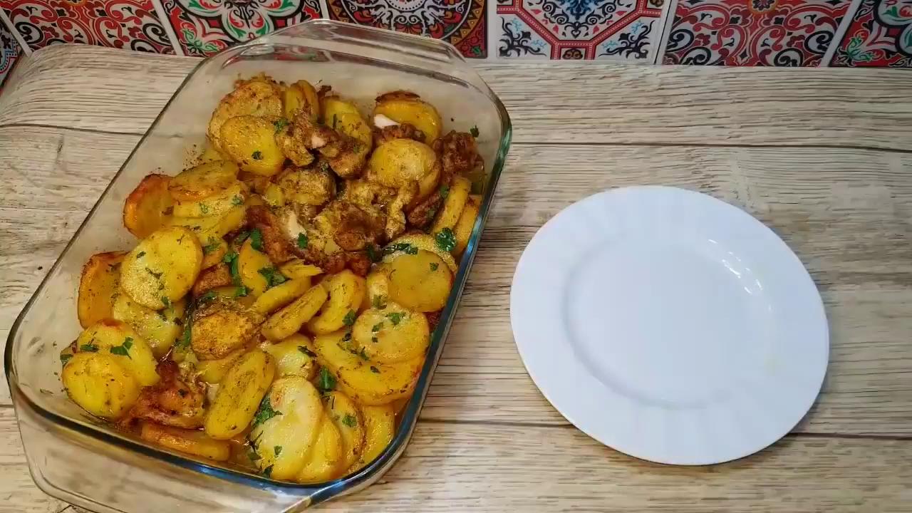 cooked chicken breast in dish of boiled potatoes